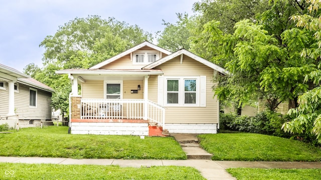 361 S Spencer Ave, Indianapolis, IN 46219 - bungalow-style house featuring covered porch and a front lawn