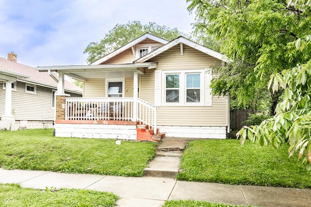 361 S Spencer Ave, Indianapolis, IN 46219 - bungalow with covered porch and a front lawn