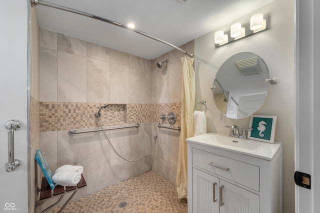 bathroom featuring vanity and a shower with shower curtain