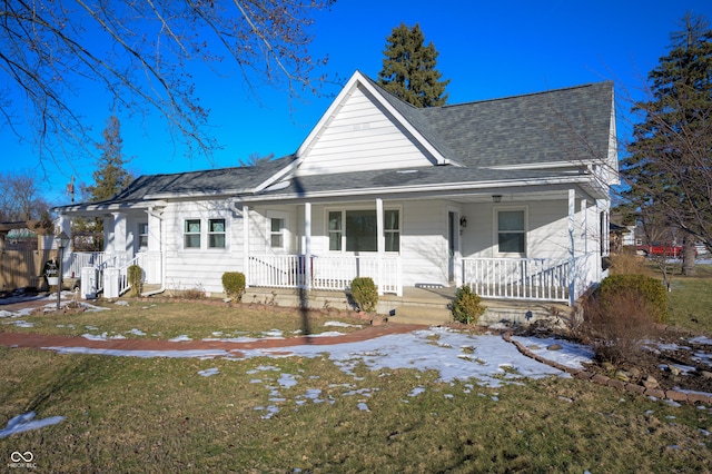 view of front of home featuring central AC, covered porch, and a front lawn