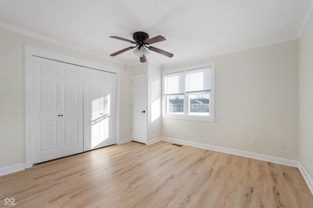 interior space with crown molding, ceiling fan, and light wood-type flooring