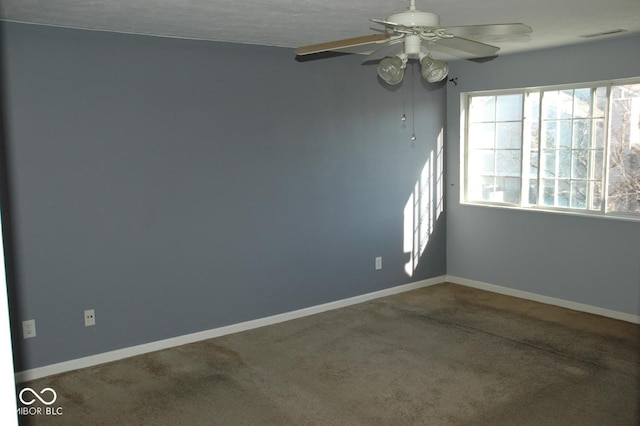 unfurnished room featuring ceiling fan and carpet