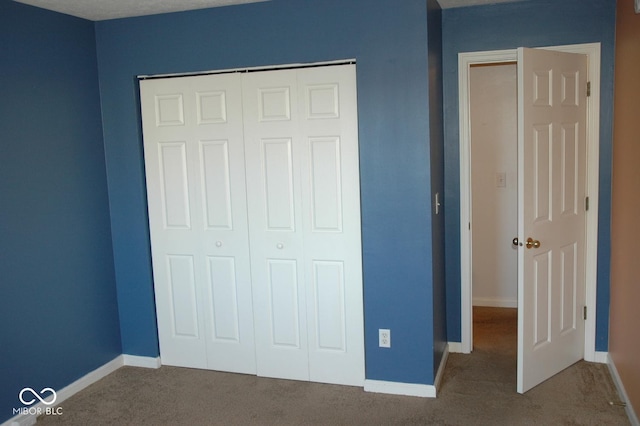 unfurnished bedroom featuring a closet and carpet