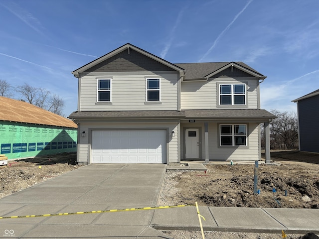 view of front of house with concrete driveway, a garage, and roof with shingles