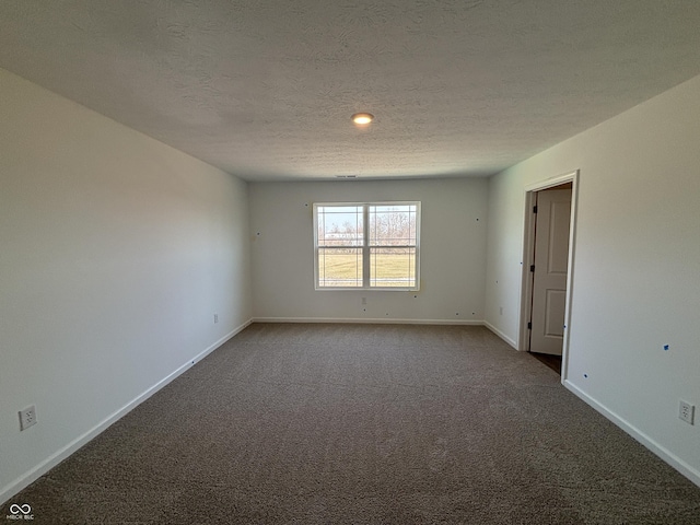 empty room featuring baseboards, a textured ceiling, and carpet flooring