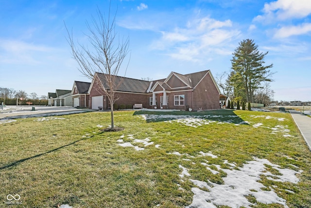 view of front of home with a garage and a front lawn