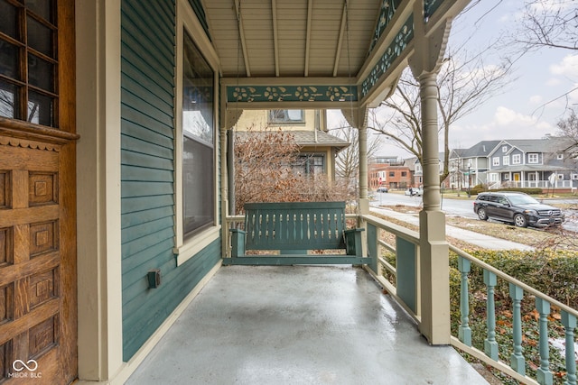 view of patio with covered porch and a residential view