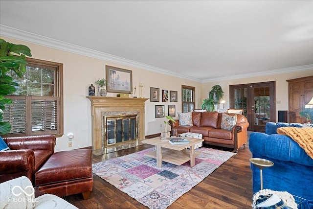 living room with crown molding, a fireplace, dark hardwood / wood-style flooring, and french doors