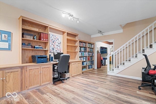 office space with track lighting and light hardwood / wood-style floors