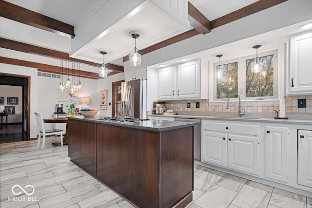 kitchen with appliances with stainless steel finishes, sink, and white cabinets