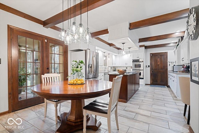 dining room with french doors and beamed ceiling