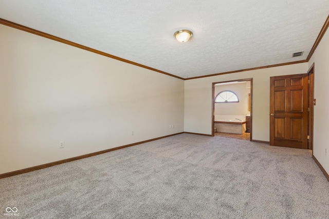 unfurnished bedroom featuring crown molding, carpet flooring, ensuite bathroom, and a textured ceiling