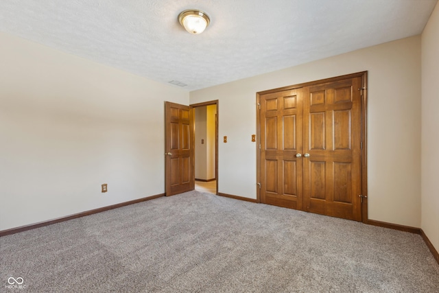 unfurnished bedroom featuring carpet floors and a textured ceiling