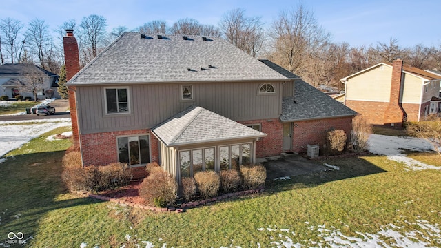 rear view of property featuring a lawn