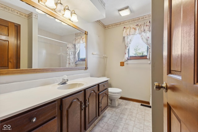 bathroom with walk in shower, vanity, and toilet