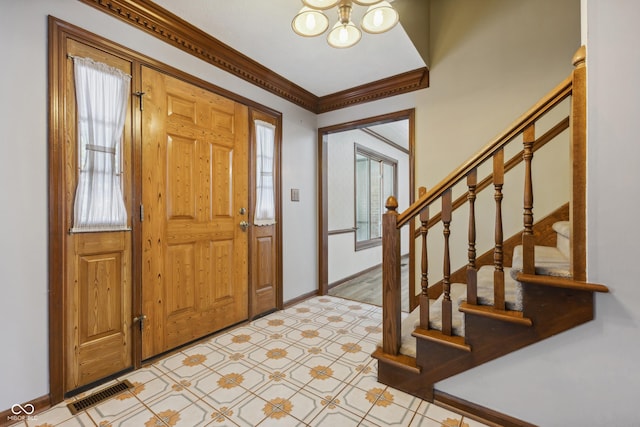 entrance foyer featuring an inviting chandelier and ornamental molding