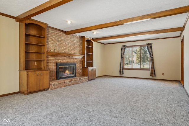 unfurnished living room with beamed ceiling, light colored carpet, a brick fireplace, and a textured ceiling