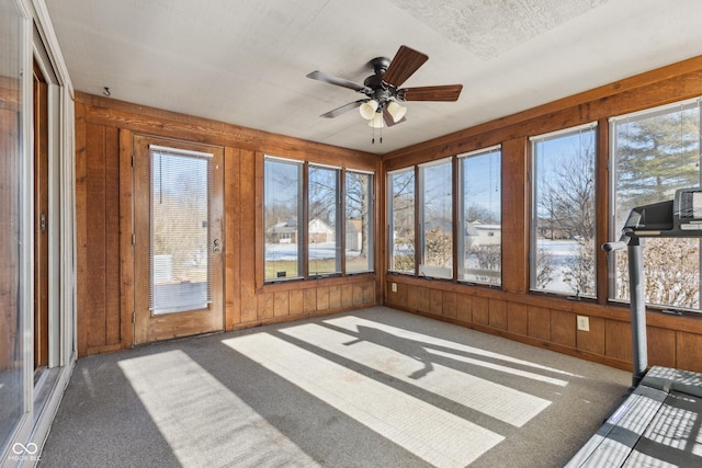 unfurnished sunroom featuring ceiling fan