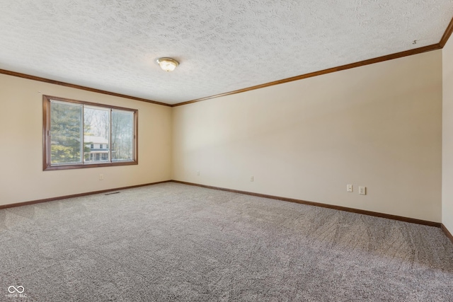 carpeted empty room featuring ornamental molding and a textured ceiling