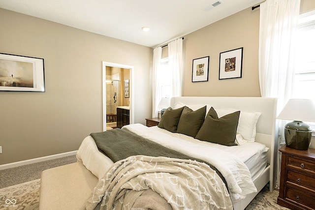 carpeted bedroom featuring ensuite bath