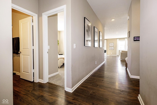 corridor with dark wood-type flooring