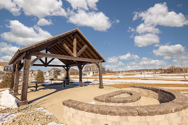 view of community with a gazebo and a fire pit