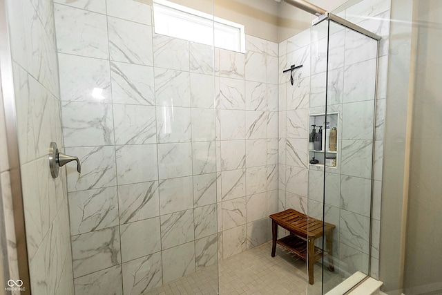 bathroom with a tile shower