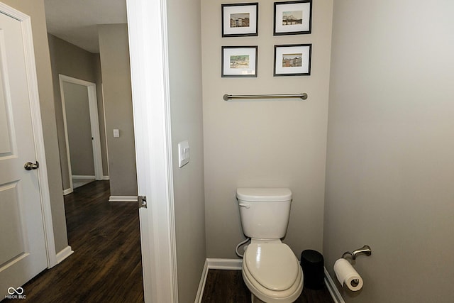 bathroom featuring hardwood / wood-style floors and toilet