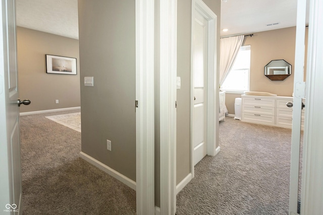 hallway with carpet floors