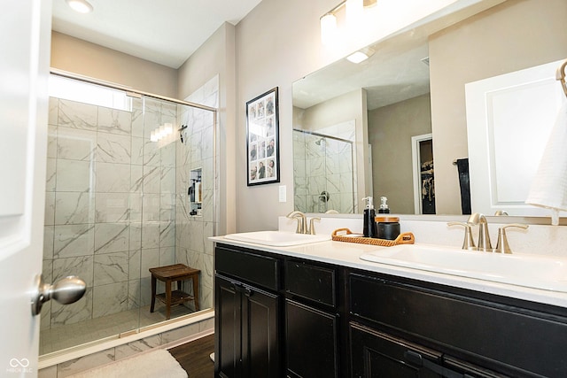 bathroom with a shower with door, wood-type flooring, and vanity