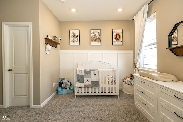 bedroom featuring a crib and carpet