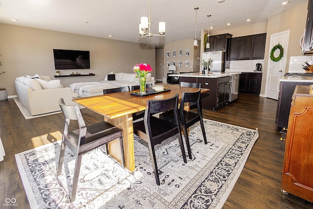 dining room featuring a notable chandelier and dark hardwood / wood-style flooring