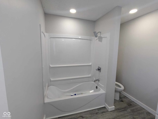 bathroom featuring shower / tub combination, wood-type flooring, and toilet