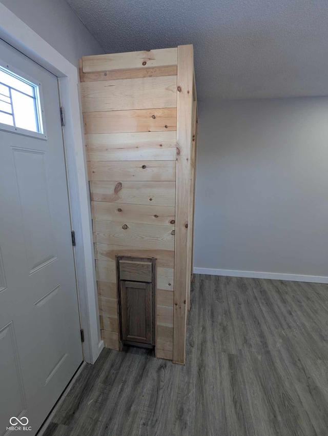 interior space with dark wood-type flooring and a textured ceiling