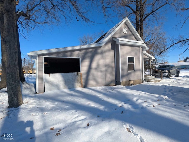 snow covered property with a garage