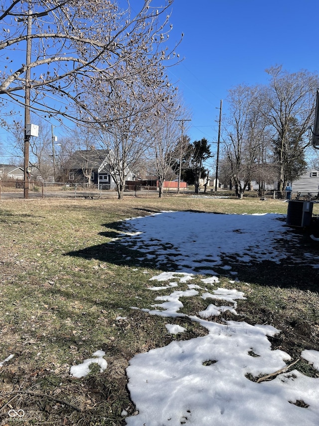 yard covered in snow featuring central AC unit