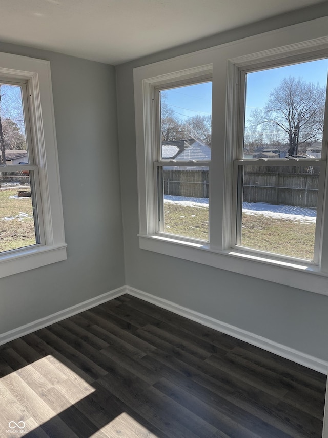 unfurnished room with dark hardwood / wood-style flooring