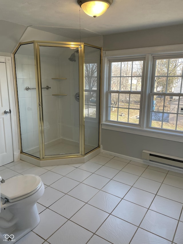 bathroom featuring tile patterned flooring, a baseboard heating unit, a shower with shower door, and toilet