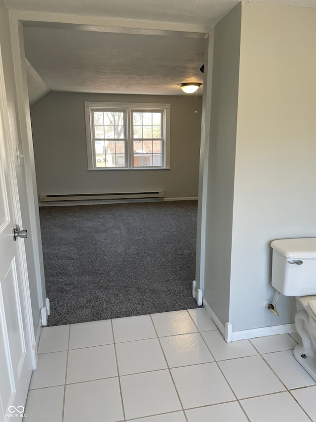 hall featuring a baseboard radiator, light colored carpet, and vaulted ceiling