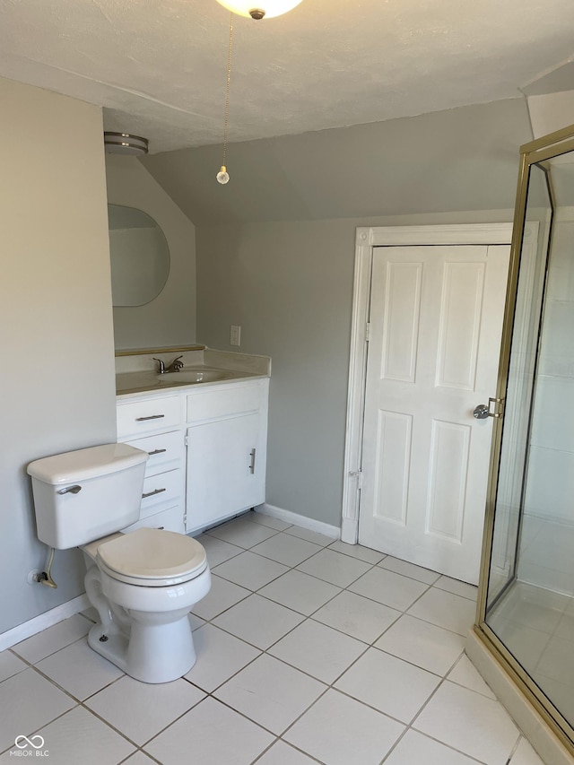 bathroom featuring vanity, vaulted ceiling, tile patterned floors, toilet, and walk in shower