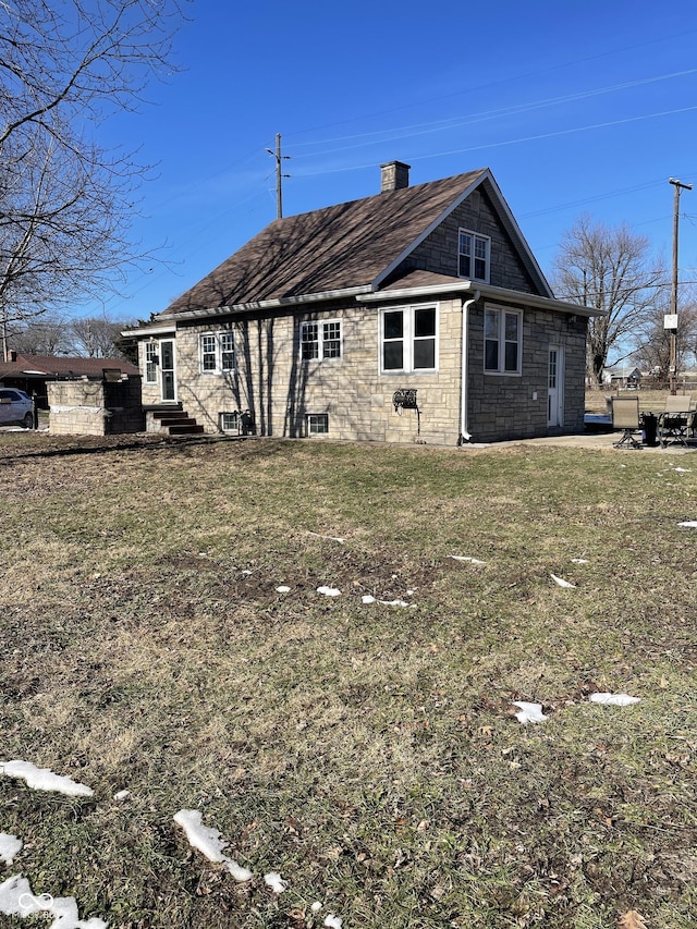 back of property featuring a yard