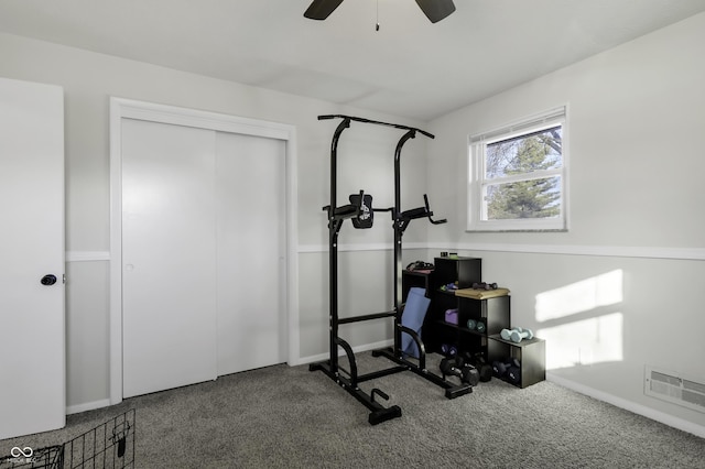 workout area featuring ceiling fan and carpet flooring