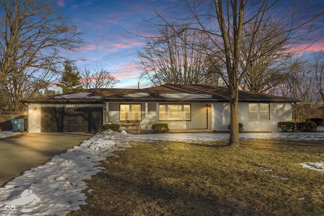 view of front of property with a garage and a yard