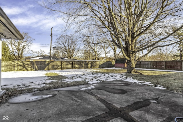 snowy yard with a storage unit