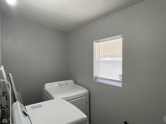 clothes washing area with washing machine and clothes dryer