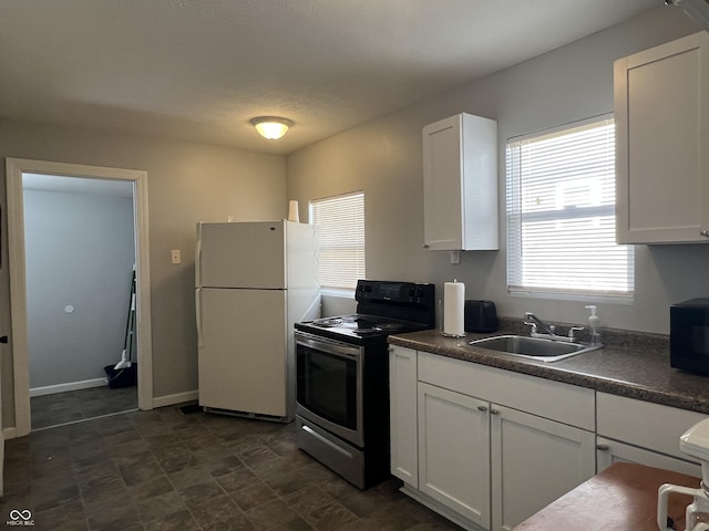 kitchen with white refrigerator, white cabinetry, stainless steel electric stove, and sink