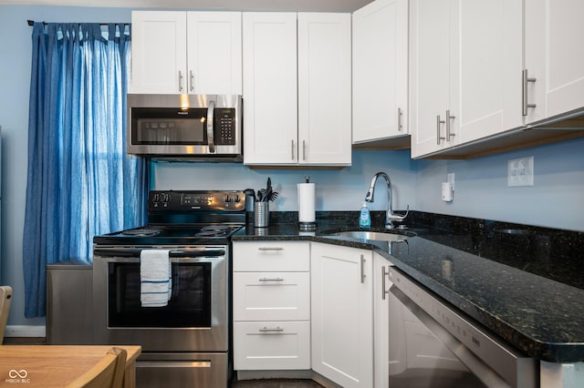 1130 S Senate Ave, Indianapolis, IN 46225 - kitchen with dark stone countertops, stainless steel appliances, sink, and white cabinets