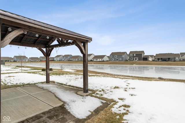 snowy yard with a gazebo