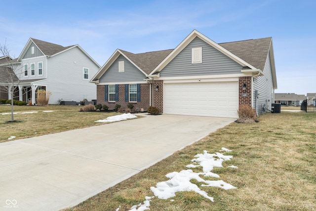 view of front of house featuring a garage, central air condition unit, and a front lawn