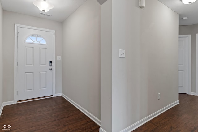 foyer entrance with dark hardwood / wood-style floors